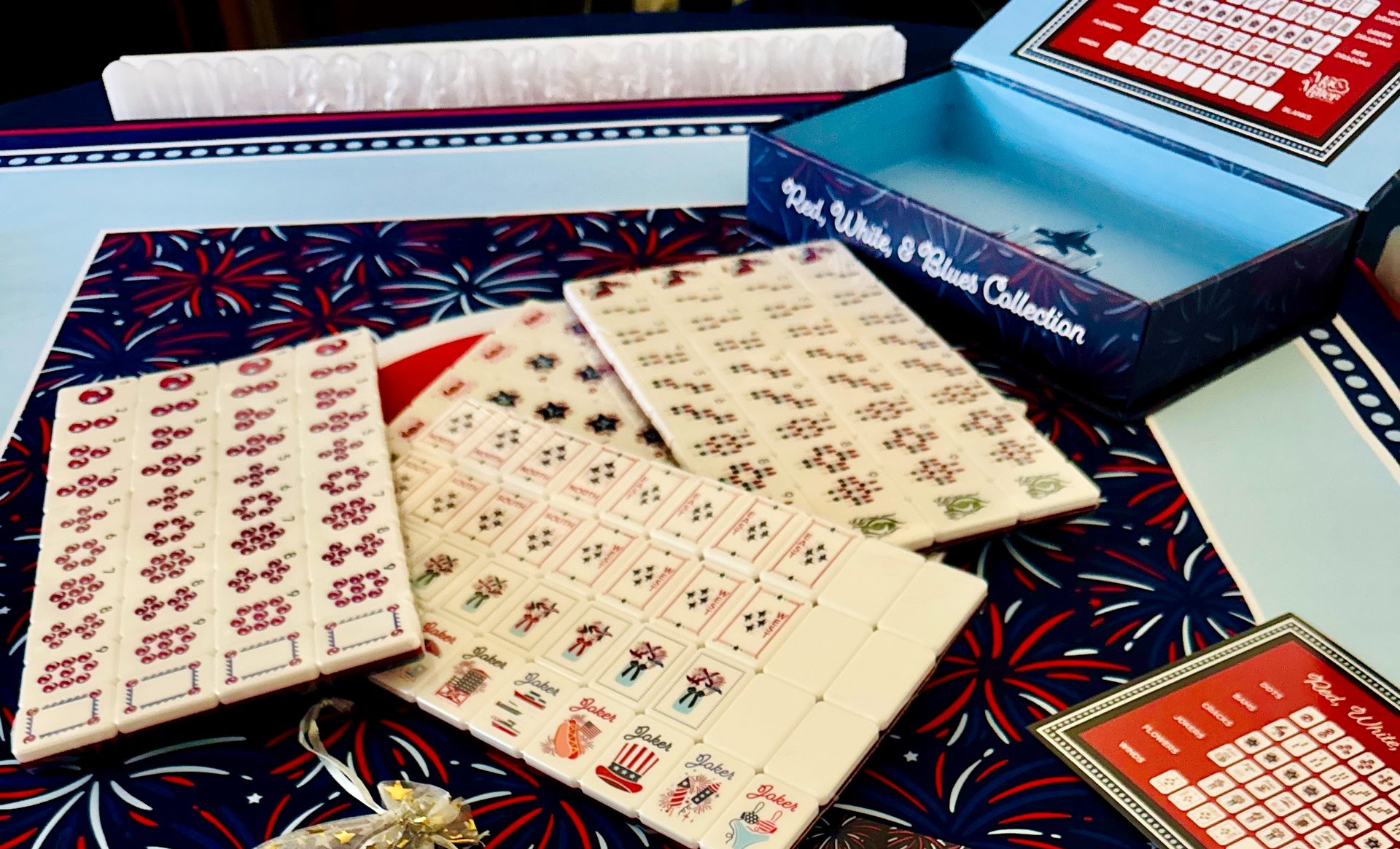 Racks of American mahjong tiles laid out on a table